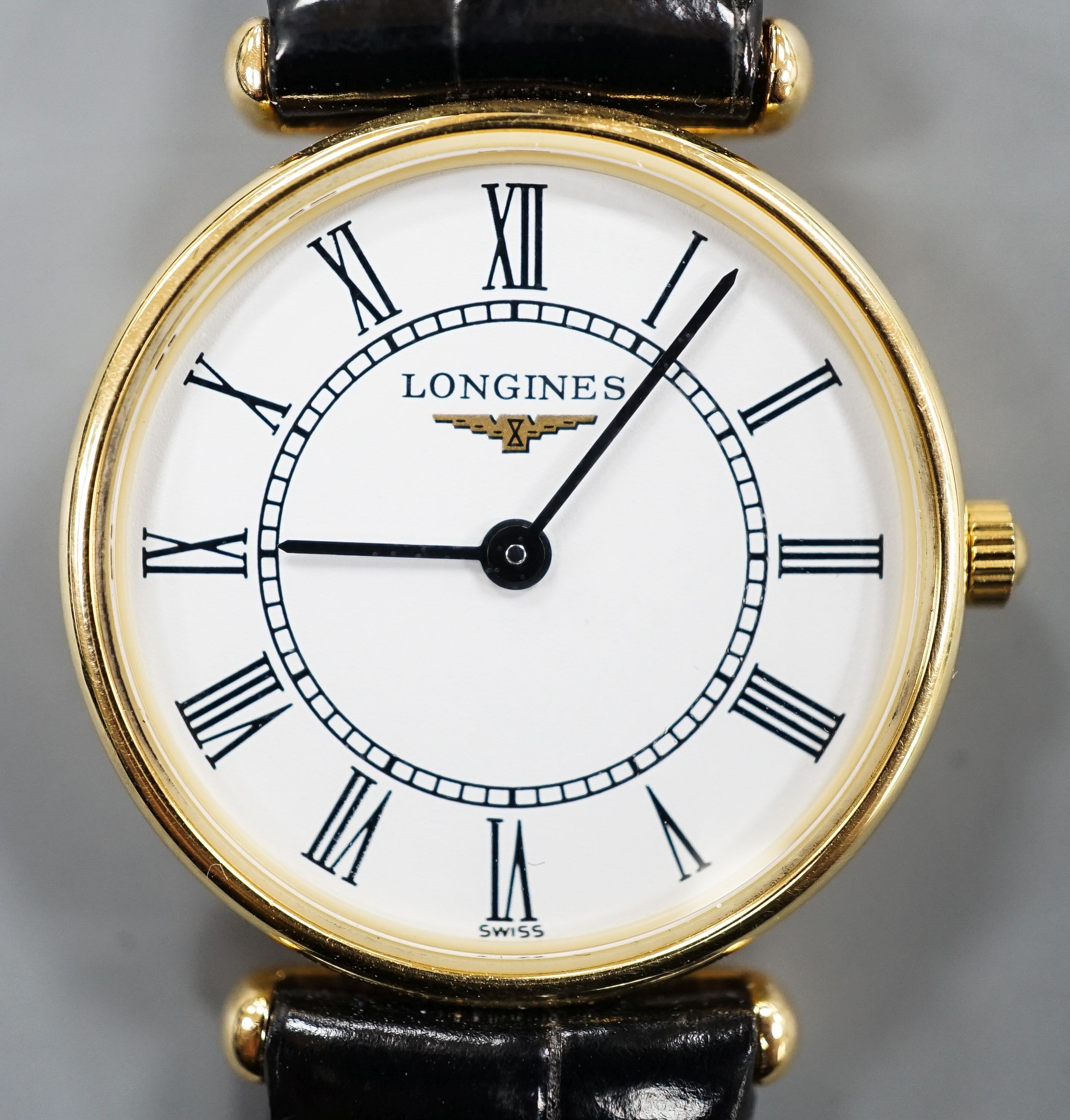 A lady's modern 18ct gold Longines Agassiz quartz wrist watch, on a Longines leather strap, case diameter 23mm, no box or papers.